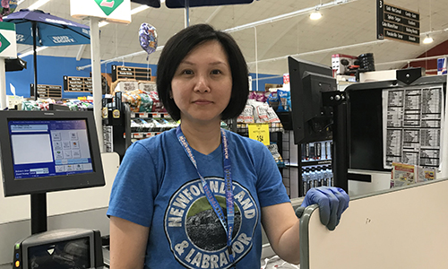 member standing at a cash register